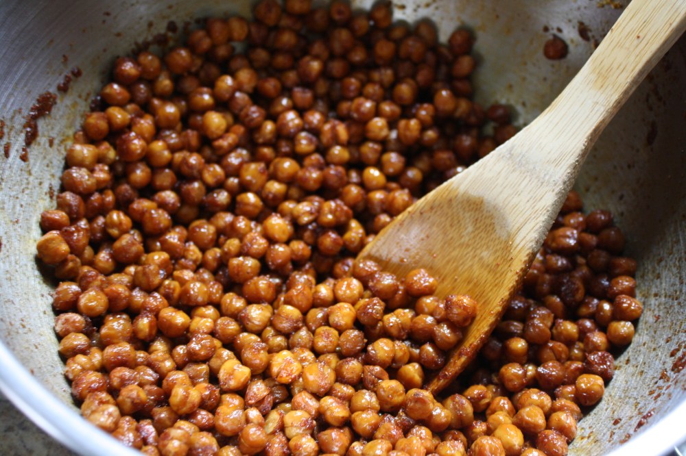 mixing chickpeas and spices with wooden spoon